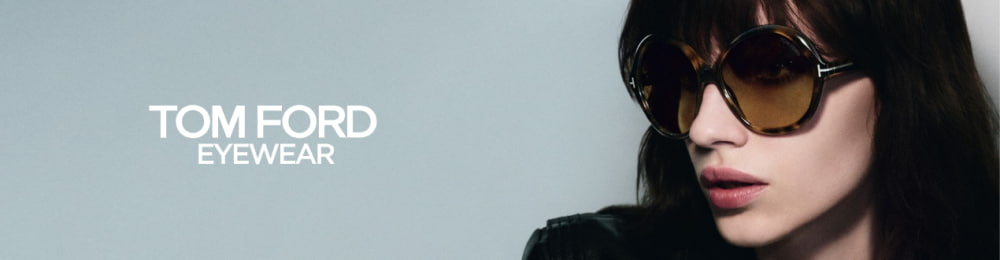 Femme portant des lunettes de soleil Tom Ford rondes et marron, avec une veste en cuir noire, sur un fond gris ; à gauche de l’image, le logo « TOM FORD EYEWEAR ».